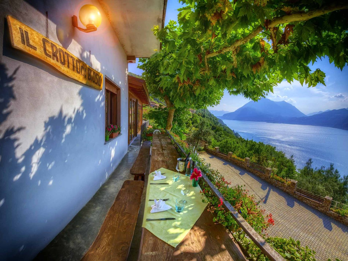 The lakeside Crotto di Biosio with tables set above Lake Como